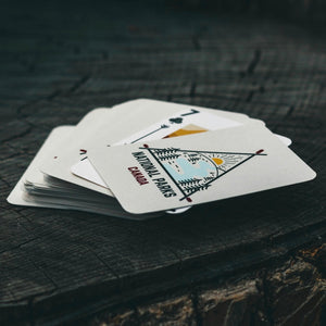 Playing cards on wooden surface with National Parks Canada written on them.
