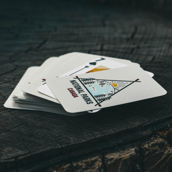 Playing cards on wooden surface with National Parks Canada written on them.