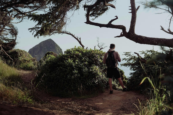 Backpacker on cliff during a Mystery Day Trip.