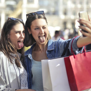 Group of friends enjoying a day trip, smiling and taking a selfie, capturing the fun and adventure of the 'Vineyards & Villages' experience in the Niagara Region.
