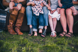 Feet of a family sitting on a couch enjoying a Mystery Day Trip together.